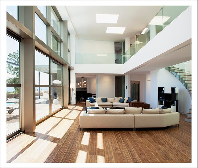 Modern two-story living room with floor-to-ceiling windows