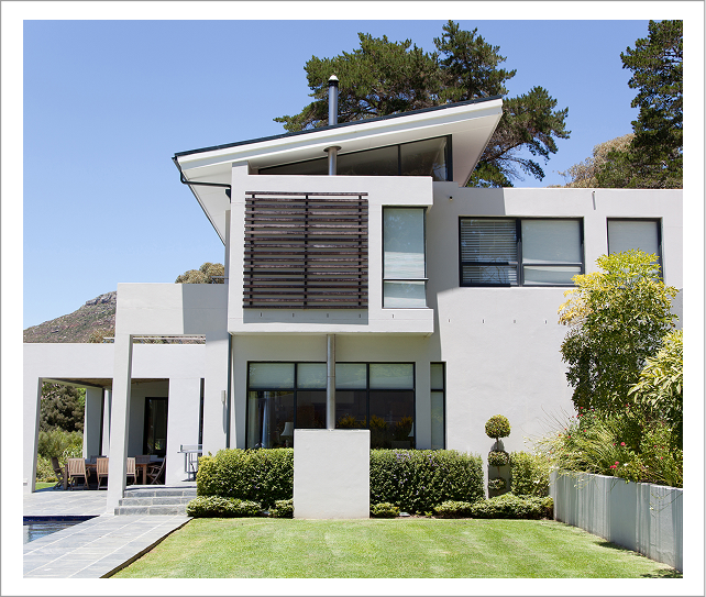 Modern white house with manicured lawn
