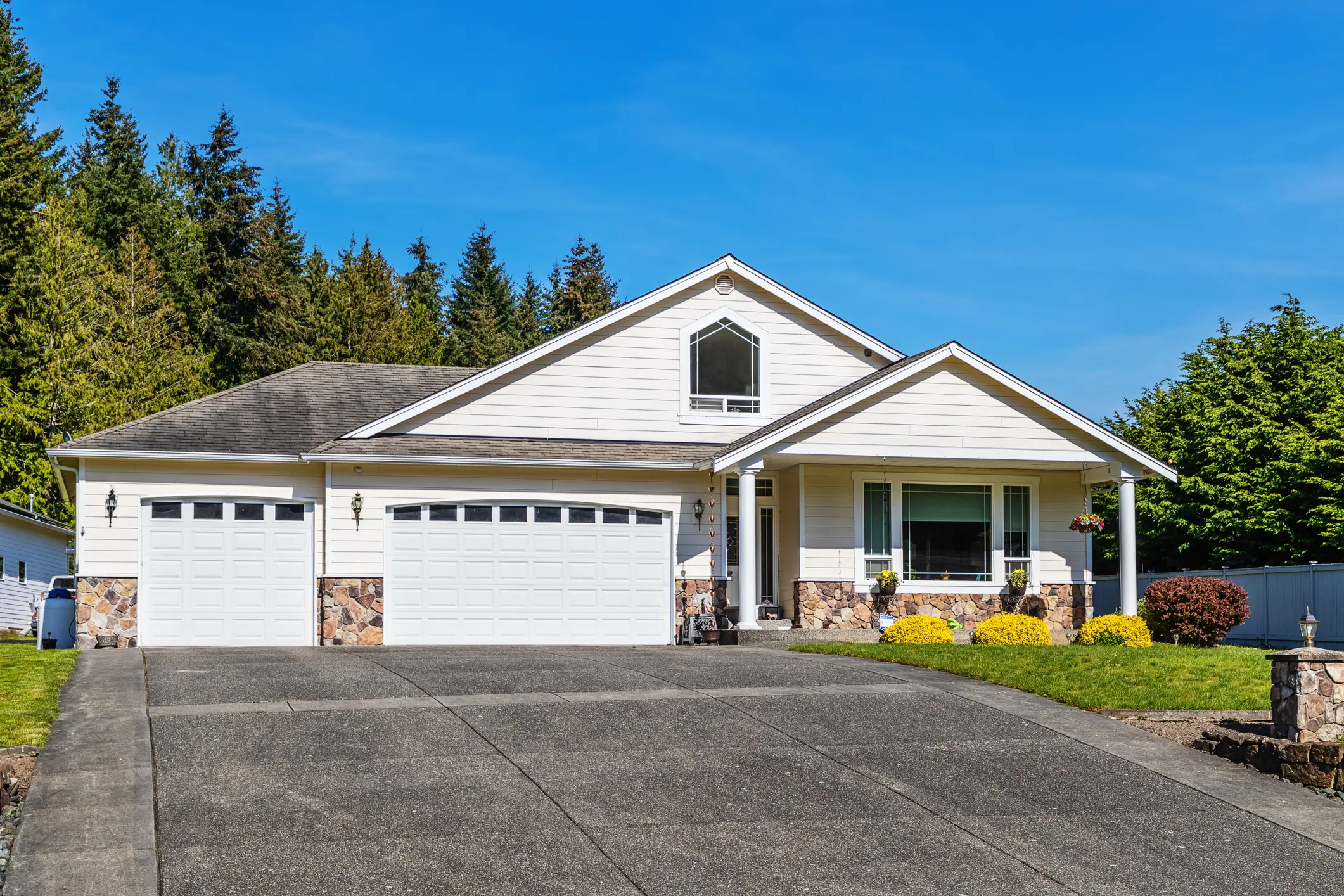 White suburban house with three-car garage